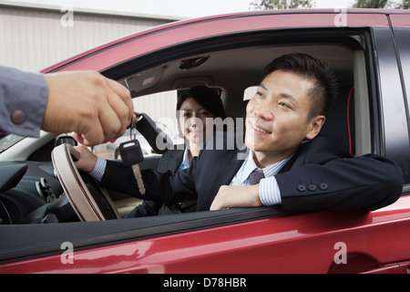 Mechanic Giving Car Keys to Couple Stock Photo