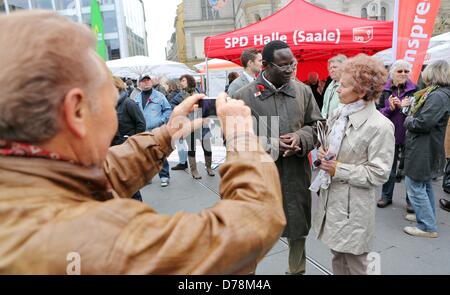 Senegal-born Karamba Diaby (L) talks passerbys on the market place in Halle, Germany, 01 May 2013. Diaby is the Bundestag candidate of the SPD in Saxony-Anhalt for the election district 72. Photo: JAN WOITAS Stock Photo