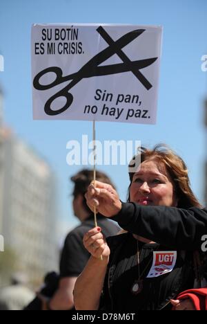 Barcelona, Spain. 1st May 2013. A woman holds up a sign with crossed out scissors during a May day demonstration in Barcelona, Spain, 01 May 2013. Photo: ANDREAS GEBERT/dpa/Alamy Live News Stock Photo