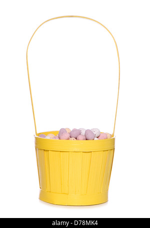 easter eggs in a yellow basket studio cutout Stock Photo