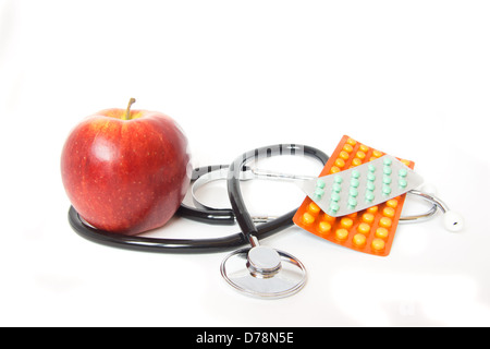 stethoscope and red apple close up isolated on white background. Healthy food and diet concept, choice fitness or illness. Stock Photo