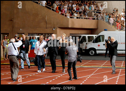 Prince Albert of Monaco and his fiancee Charlene Wittstock greet the audience before The Eagles perform in concert at Stade Stock Photo