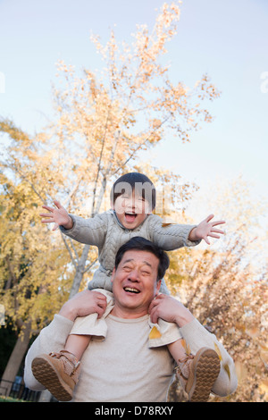 Grandfather and Grandson Playing in the Park Stock Photo
