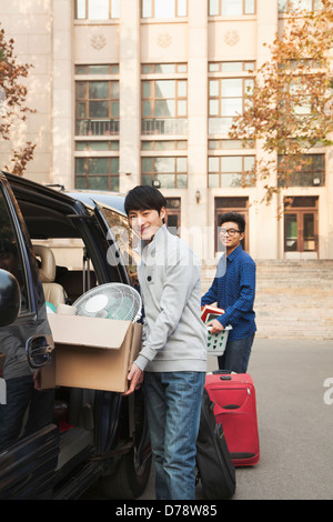 Students moving into dormitory on college campus Stock Photo