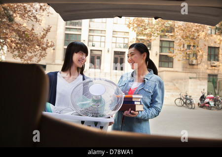 Sisters moving into dormitory at college Stock Photo