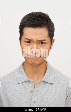 Portrait of angry and frustrated young man, studio shot Stock Photo