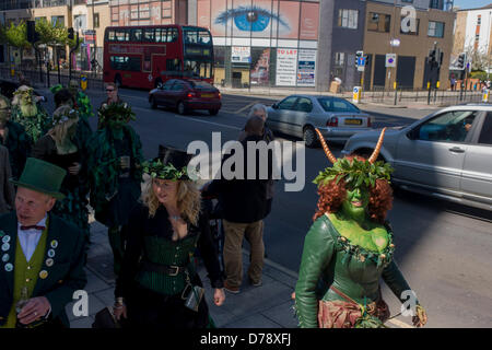 London, UK. 1st May 2013. Members of the Deptford Jack in the Green dance from pub to pub to Greenwich to mark the start of spring. Participants wear traditional green faces and forest foliage, a tradition from the 17th Century custom of milkmaids going out on May Day with the utensils of their trade decorated with garlands and piled into a pyramid which they carried on their heads. Credit:  RichardBakerNews / Alamy Live News Stock Photo