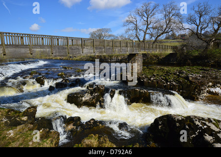 Wooden Footbridge over Linton Falls on The River Wharfe on the Dales Way Long Distance Footpath Wharfedale Yorkshire Stock Photo