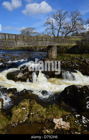 Wooden Footbridge over Linton Falls on The River Wharfe on the Dales Way Long Distance Footpath Wharfedale Yorkshire Stock Photo