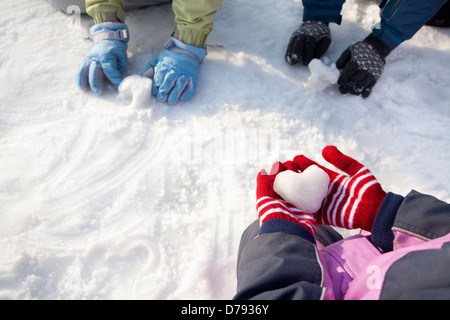 Close-up of Hands in Winter Gloves Playing in the Snow Stock Photo