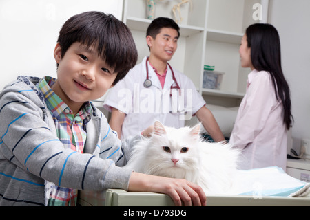 Boy with pet dog in veterinarian's office Stock Photo