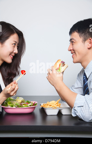 Two young business people eating a meal Stock Photo