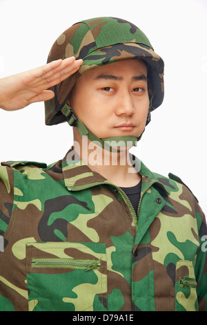 Portrait of man in military uniform saluting Stock Photo