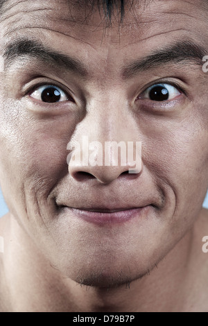 Close up of young mans face smiling Stock Photo