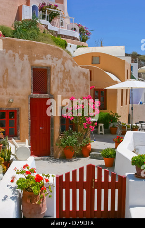 Colorful quiet backyard with beautiful flowers and classic traditional architecture in Santorini, Fira, Greece Stock Photo