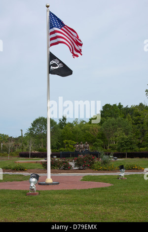Flags with a cast of Three Soldiers in background at Veterans Memorial Plaza, Apalachicola, Florida, USA Stock Photo