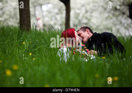 A romantic walk on Petrin hill, Prague Czech Republic couple sitting in grass park Two lovers Stock Photo