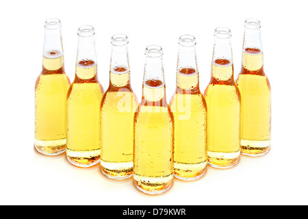 beer bottles group of 7 with water drops isolated on white Stock Photo