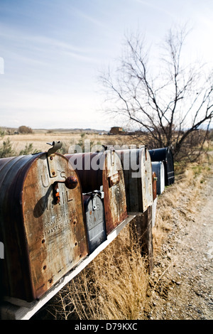 mailboxes in midwest United States, old vintage boxes in late sun rusting away Stock Photo