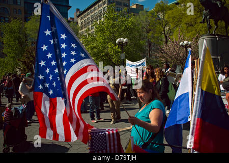 Wednesday, May 1, 2013, New York, NY, US:  A vendor sells United States flags as protesters, some calling for an end to capitalism, gather in New York's Union Square to mark  International Workers' Day, also known as May Day. Stock Photo