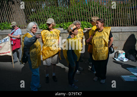 Wednesday, May 1, 2013, New York, NY, US:  A group of older women wearing 'Granny Peace Brigade' smocks waits for a march to begin, as protesters gather in New York's Union Square to mark  International Workers' Day, also known as May Day. Stock Photo