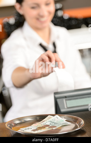 Cash and young cashier giving receipt in bar CZK Stock Photo