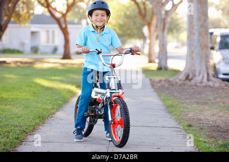 Boy Wearing Safety Helmet Riding Bike Stock Photo