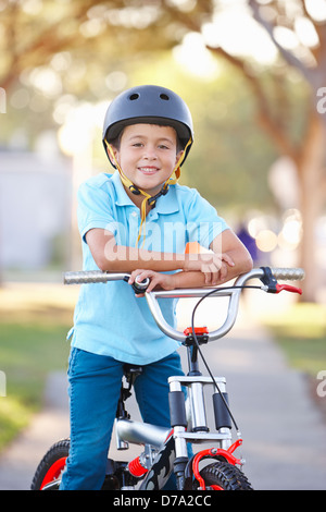 Boy Wearing Safety Helmet Riding Bike Stock Photo