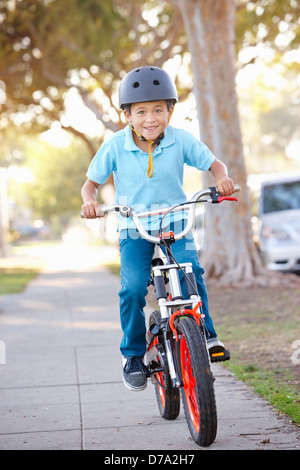 Boy Wearing Safety Helmet Riding Bike Stock Photo