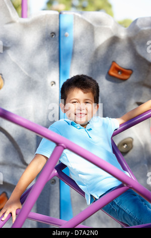 Boy On Climbing Frame In Park Stock Photo