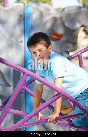 Boy On Climbing Frame In Park Stock Photo