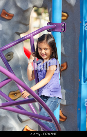 Girl On Climbing Frame In Park Stock Photo