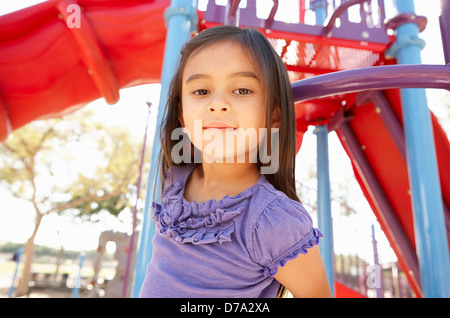 Girl On Climbing Frame In Park Stock Photo