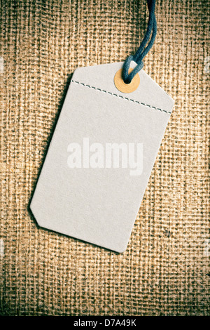 the blank price tag label on burlap background Stock Photo