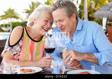 Senior Couple Enjoying Meal In Outdoor Restaurant Stock Photo