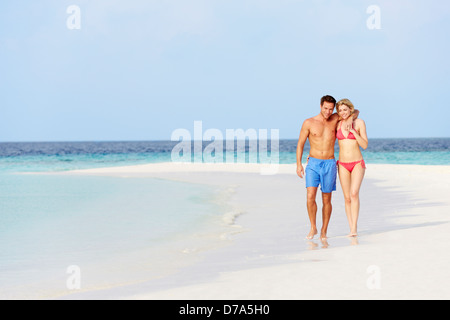 Romantic Couple Walking On Beautiful Tropical Beach Stock Photo