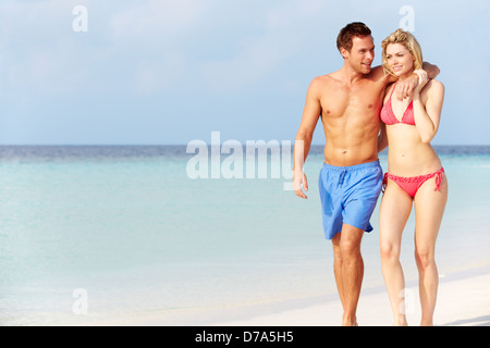Romantic Couple Walking On Beautiful Tropical Beach Stock Photo