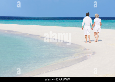 Senior Romantic Couple Walking On Beautiful Tropical Beach Stock Photo