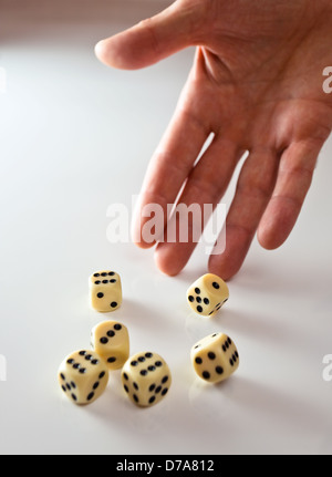 The hand of the person throwing cubes for dicing. Stock Photo