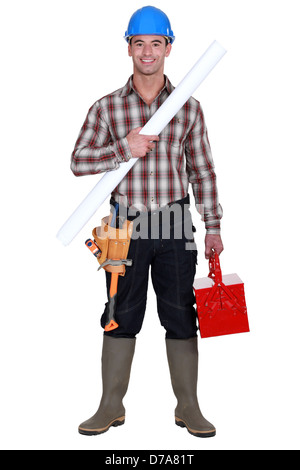 craftsman holding a blueprint and a toolbox Stock Photo