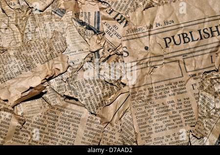 An old crumpled and torn newspaper for a background. Stock Photo