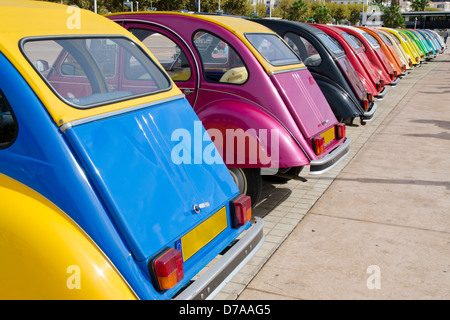 Row of colourful Citroen 2CV motor cars parked on the seafront promenade during a rally in Cannes, Alpes-Maritimes 06, France Stock Photo