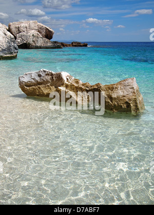Big rocks in the shallow emerald sea on a beach on the Costa Smeralda in Sardinia, Italy. Stock Photo