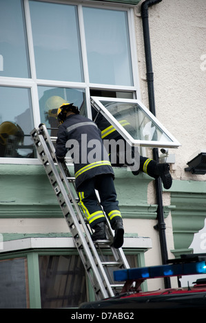 Window Stack Firefighter Fireman climbing a ladder at a fire Stock Photo - Alamy