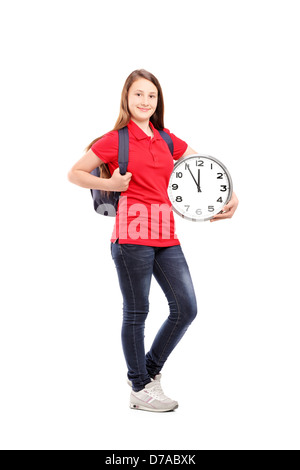 Full length portrait of a female student holding a wall clock isolated on white background Stock Photo