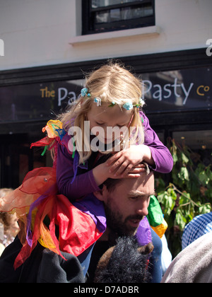 Young girl being carried on her father's shoulders, UK 2013 Stock Photo