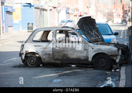 stolen abandoned car burnt out riot rioting Stock Photo
