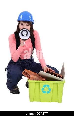 A female construction worker promoting recycling. Stock Photo