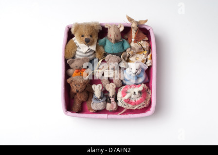 From a series called 'The Pink Box Project'. A collection of miniature teddy bears and mice framed in a pink box. Stock Photo
