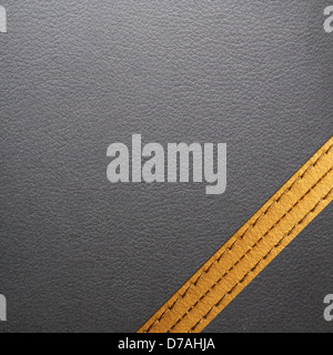 Black leather texture for background with yellow seam Stock Photo